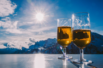 Glass of beer with the Serre Chevalier Alps in the background, France