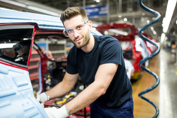 Portrait of confident man working in modern car factory