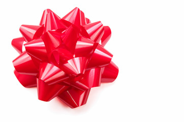 Voluminous gift bow in bright shiny red on white background