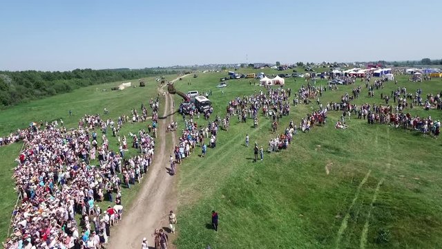Dron top view many crowded people on open field modern celebration in suny day