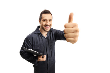 Cheerful male worker with a clipboard showing thumbs up