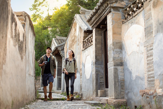 Young Chinese couple hiking in village