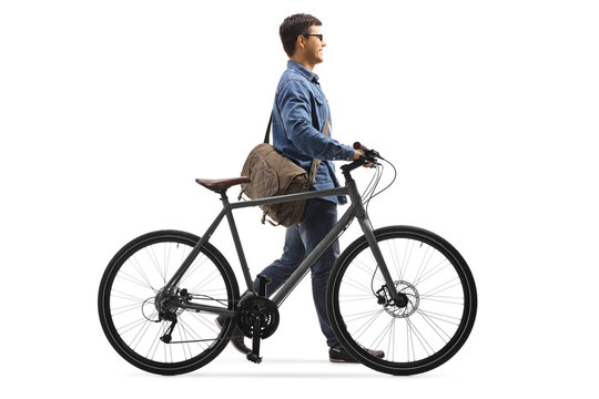 Guy in denim clothes walking and pushing a bicycle - Powered by Adobe