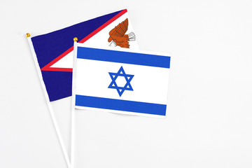 Israel and American Samoa stick flags on white background. High quality fabric, miniature national...