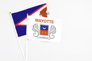 Mayotte and American Samoa stick flags on white background. High quality fabric, miniature national flag. Peaceful global concept.White floor for copy space.