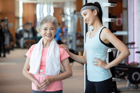 Senior Chinese woman taking a break after exercising at gym