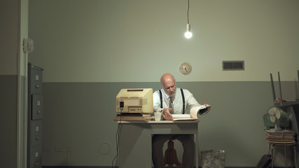 Sad businessman working in a small office