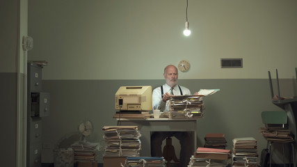 Frustrated businessman overloaded with paperwork