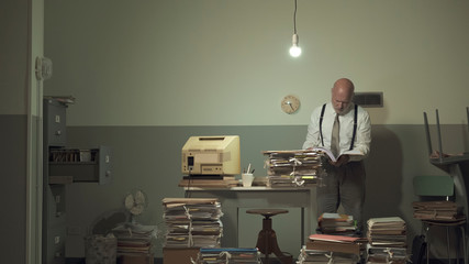 Businessman working in a messy office