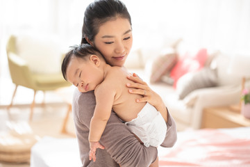 Young Chinese mom holding baby girl