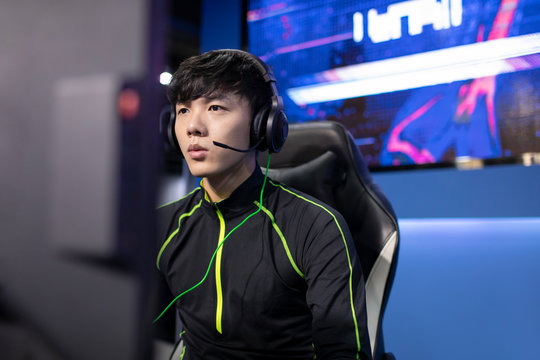 Young Chinese man playing esports