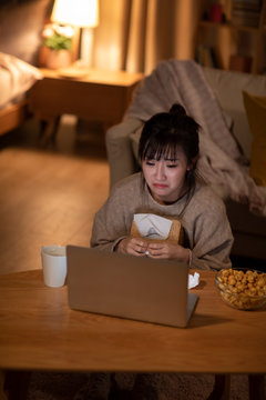 Young Chinese Woman Watching Movie On Laptop