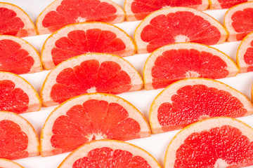 Obraz na płótnie Canvas Grapefruit red juicy slices background. top view.