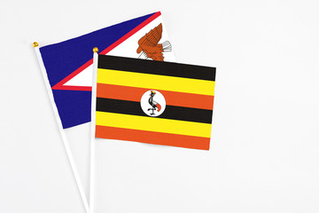 Uganda and American Samoa stick flags on white background. High quality fabric, miniature national...