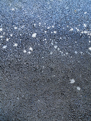 wet asphalt in cracks, visible paint residues blurred by abstract spots. abstract unusual background