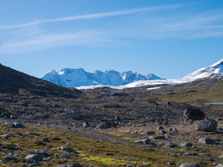 View on highest snow covered mountain peaks in Norway and Scandinavia, Jotunheimen National Park. Sunny day, blue sky background