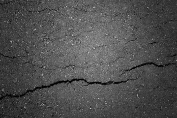 Obraz premium Top view of an old cracked abandoned pedestrian asphalt path made of small stones. Beautiful modern abstract trendy grunge texture background. Design element.