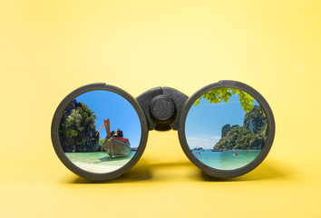 Binoculars on yellow background