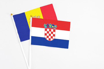 Croatia and Andorra stick flags on white background. High quality fabric, miniature national flag. Peaceful global concept.White floor for copy space.