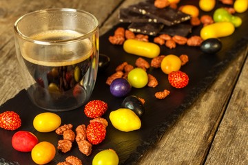 Coffee and candies on the table. Multicolored sweets. unhealthy food. Coffee sweets. Risk of diabetes.