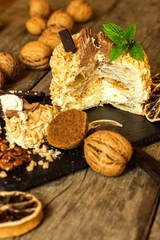 Sweet dessert. Walnut dessert. Tart on wooden table. Unhealthy food. Risk of diabetes. Walnuts.