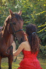 Fototapeta premium Beautiful young woman with horse outdoors