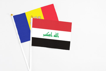 Iraq and Andorra stick flags on white background. High quality fabric, miniature national flag. Peaceful global concept.White floor for copy space.