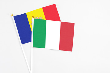 Italy and Andorra stick flags on white background. High quality fabric, miniature national flag. Peaceful global concept.White floor for copy space.