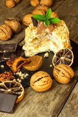 Sweet dessert. Walnut dessert. Tart on wooden table. Unhealthy food. Risk of diabetes. Walnuts.
