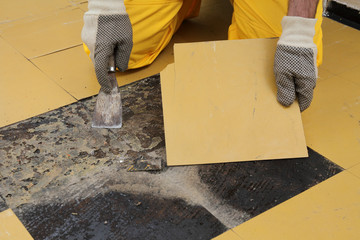 Old vinyl tiles removal from floor in a room or kitchen