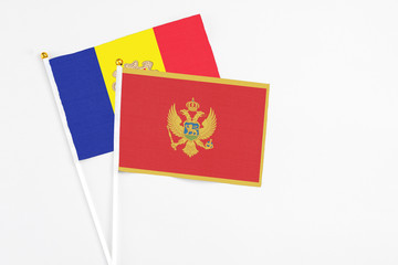 Montenegro and Andorra stick flags on white background. High quality fabric, miniature national flag. Peaceful global concept.White floor for copy space.