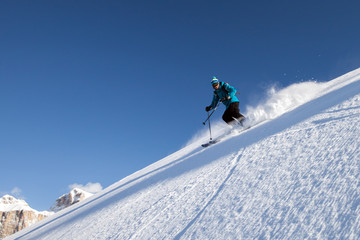skier on a black slope in the mountains