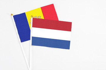 Netherlands and Andorra stick flags on white background. High quality fabric, miniature national flag. Peaceful global concept.White floor for copy space.