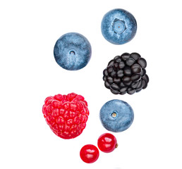 Falling wild berries mix isolated on white background, top view. Strawberry, Raspberry, Blueberry...