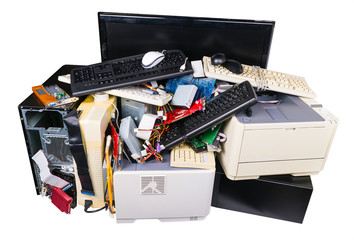 Pile of discarded computer parts isolated on white background. Used hardware components as keyboards, printers or PC cases. Eco separation, recycling and disposal of electronic metal or plastic waste.