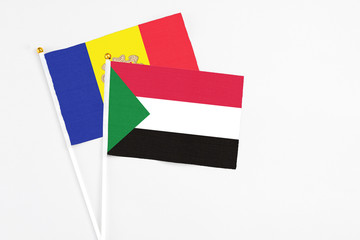 Sudan and Andorra stick flags on white background. High quality fabric, miniature national flag. Peaceful global concept.White floor for copy space.