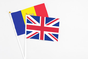 United Kingdom and Andorra stick flags on white background. High quality fabric, miniature national flag. Peaceful global concept.White floor for copy space.