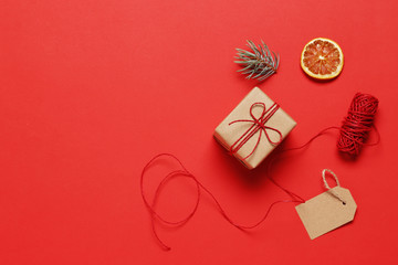 composition of craft gift boxes and Christmas items on a red background. place for text. Top view.