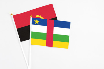 Central African Republic and Angola stick flags on white background. High quality fabric, miniature national flag. Peaceful global concept.White floor for copy space.
