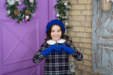 Love gesture. Fashion girl ready for Christmas celebration. Little fashionista wearing gloves. Small girl child in Christmas dress. Fashionable little child. Lovely kid. Merry christmas concept