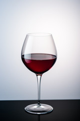 red wine in a wine glass on the background