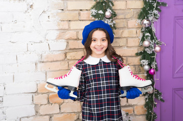 Winter leisure. Cute skates. Active and fun. Professional skating equipment. Small child hold...