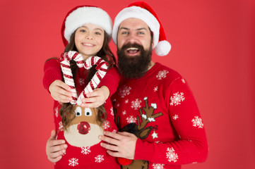 Christmas games. Share joy and happiness. Christmas Carol. Father and daughter with candy canes christmas decorations. Family holiday. Santa claus family look. Bearded dad and cheerful little girl