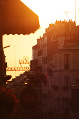 Parisian houses backlit during sunset in the Montmartre district in Paris, France