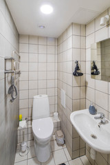 Bathroom interior with white tile. Toilet room.
