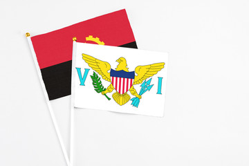 United States Virgin Islands and Angola stick flags on white background. High quality fabric, miniature national flag. Peaceful global concept.White floor for copy space.