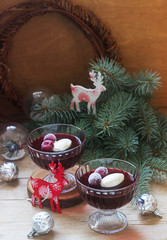 Cherry jelly with cream and berries in a Christmas or New Year decoration.