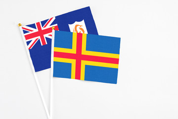Aland Islands and Anguilla stick flags on white background. High quality fabric, miniature national...