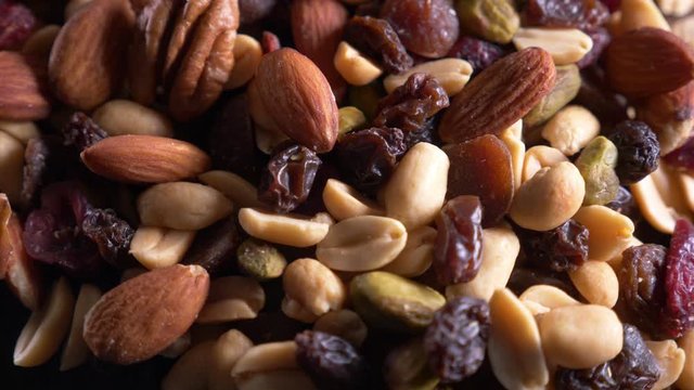 Roasted and salted nuts (mixed) on an old wooden table