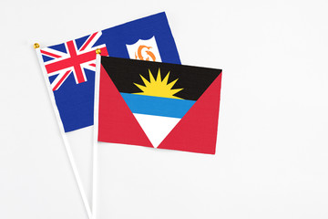 Fototapeta premium Antigua and Barbuda and Anguilla stick flags on white background. High quality fabric, miniature national flag. Peaceful global concept.White floor for copy space.